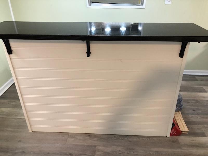 Small basement finish — custom bar counter with black granite top