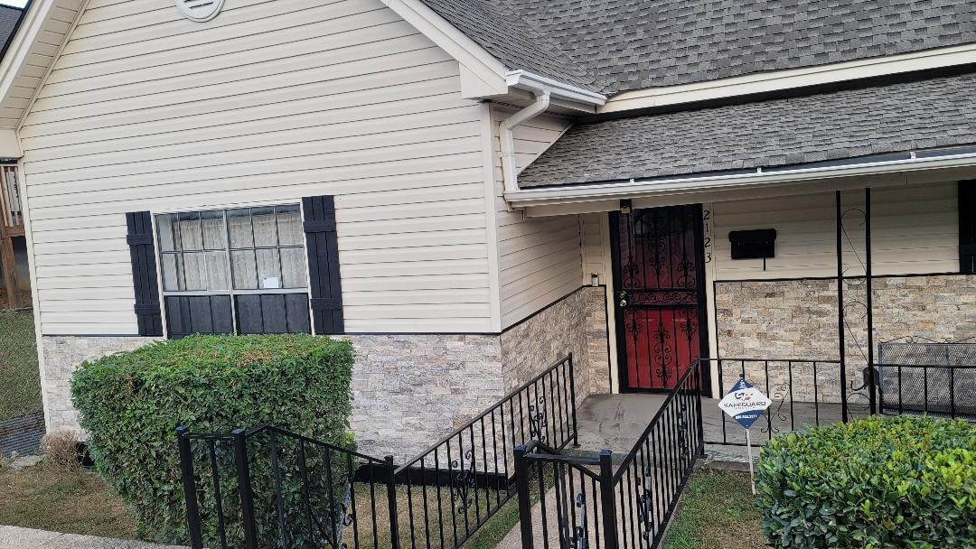 Exterior siding repair — side angle with shutters